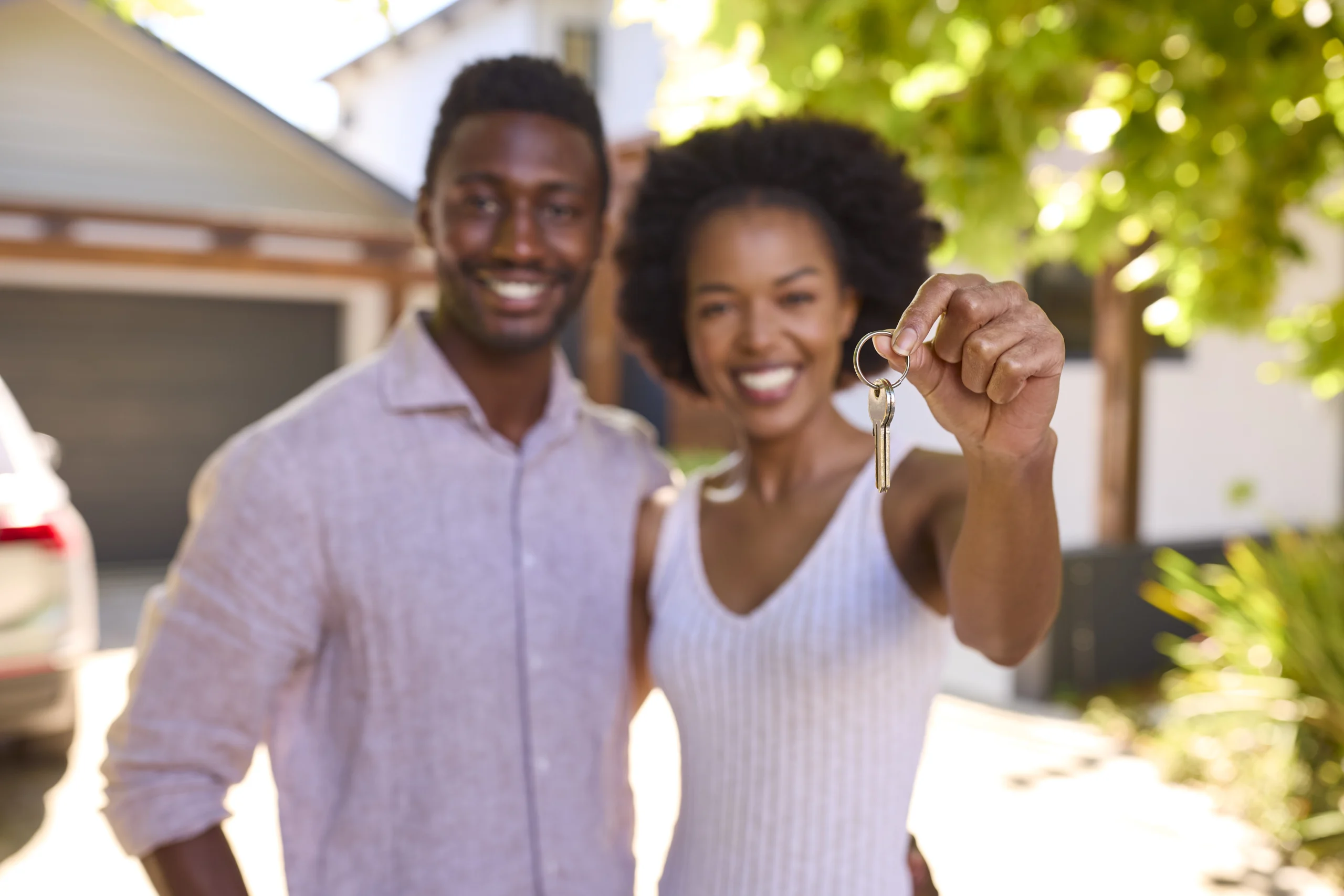 portrait of couple outdoors holding keys to dream IFB