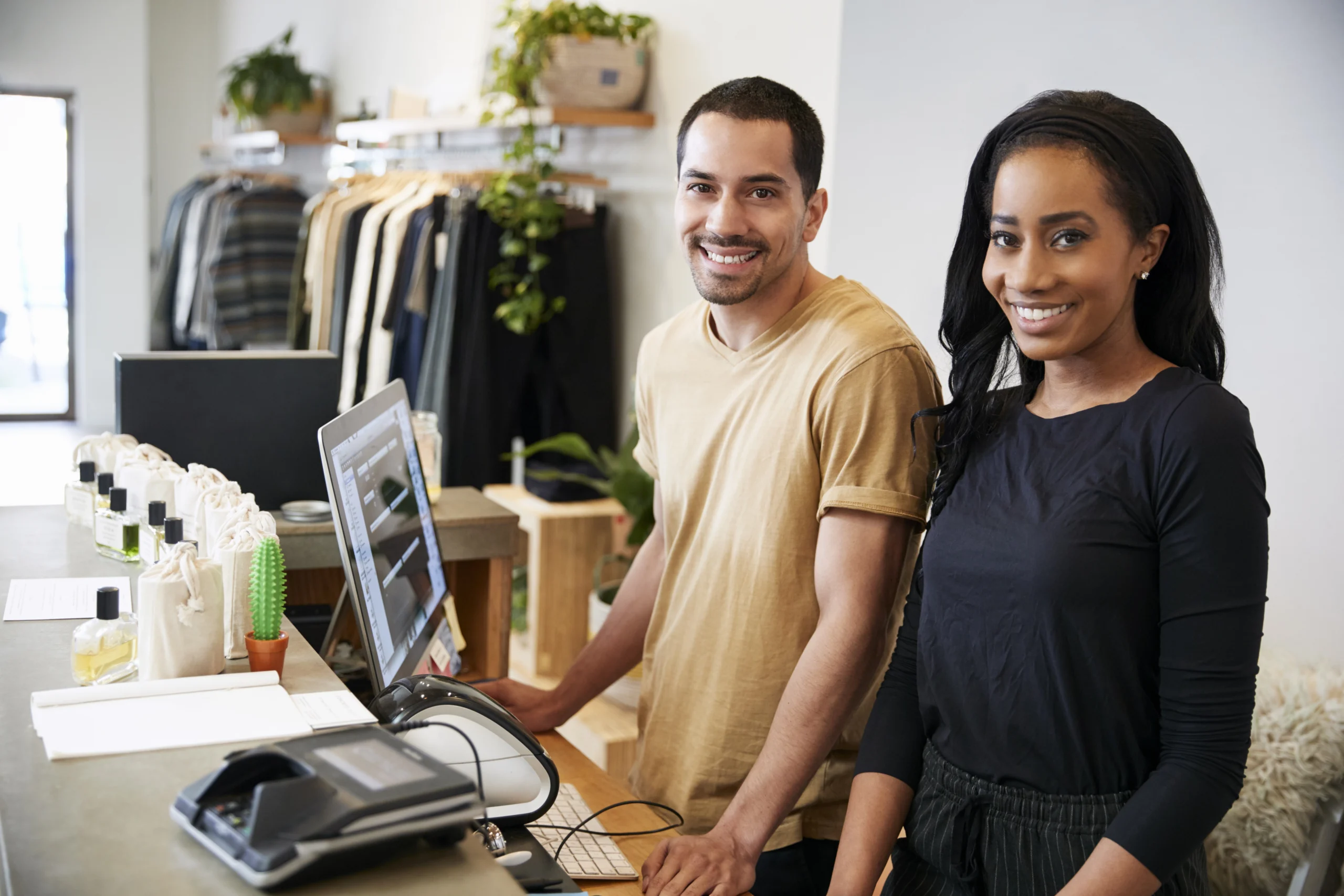smiling colleagues behind the counter in clothing IFB
